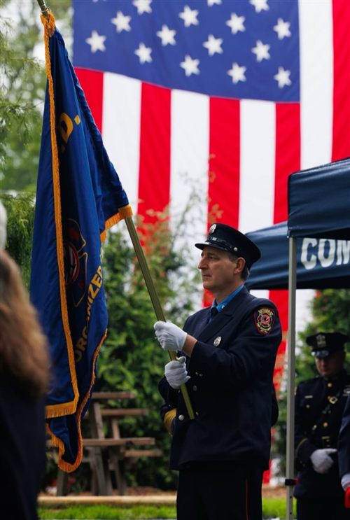 Kevin Urso in his volunteer firefighter dress uniform, presenting the colors at a memorial ceremony